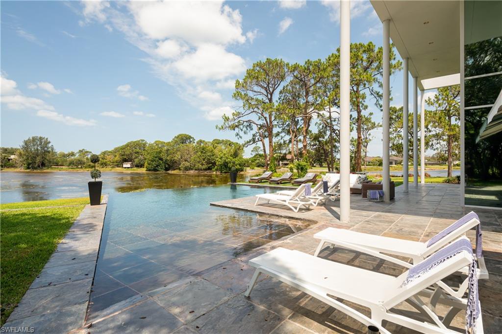 427 Ridge Court Naples, FL 34108 - Photo 37 of 49 a view of swimming pool with outdoor seating and plants