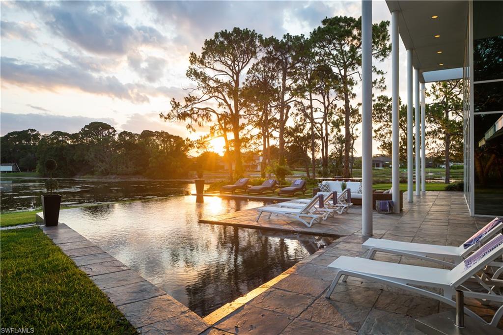 427 Ridge Court Naples, FL 34108 - Photo 38 of 49 a view of a lake with a patio