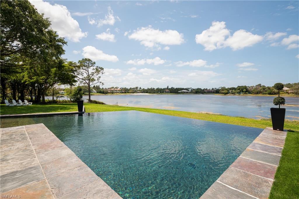 427 Ridge Court Naples, FL 34108 - Photo 42 of 49 a view of swimming pool with an outdoor seating and yard
