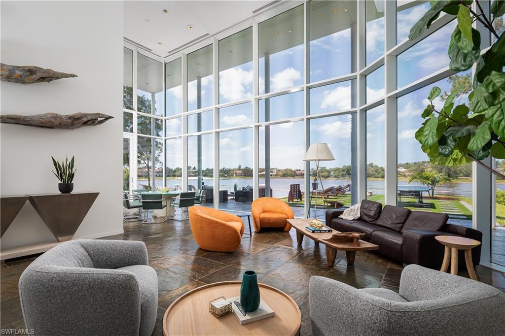 427 Ridge Court Naples, FL 34108 - Photo 6 of 49 a living room with furniture and floor to ceiling windows