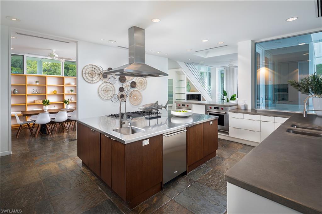 427 Ridge Court Naples, FL 34108 - Photo 10 of 49 a kitchen with stainless steel appliances kitchen island granite countertop a stove and a sink