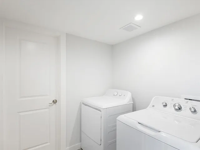 a view of storage and utility room with dryer and washer
