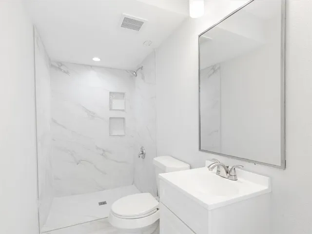 a bathroom with a sink toilet and shower