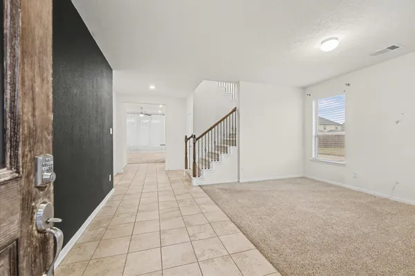 a view of entryway and hall with a rug