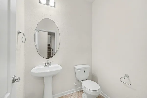 a view of a kitchen with refrigerator and cabinets
