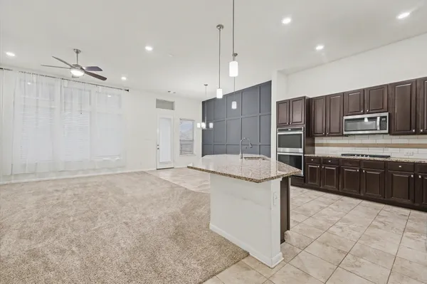 a kitchen with granite countertop stainless steel appliances and wooden cabinets