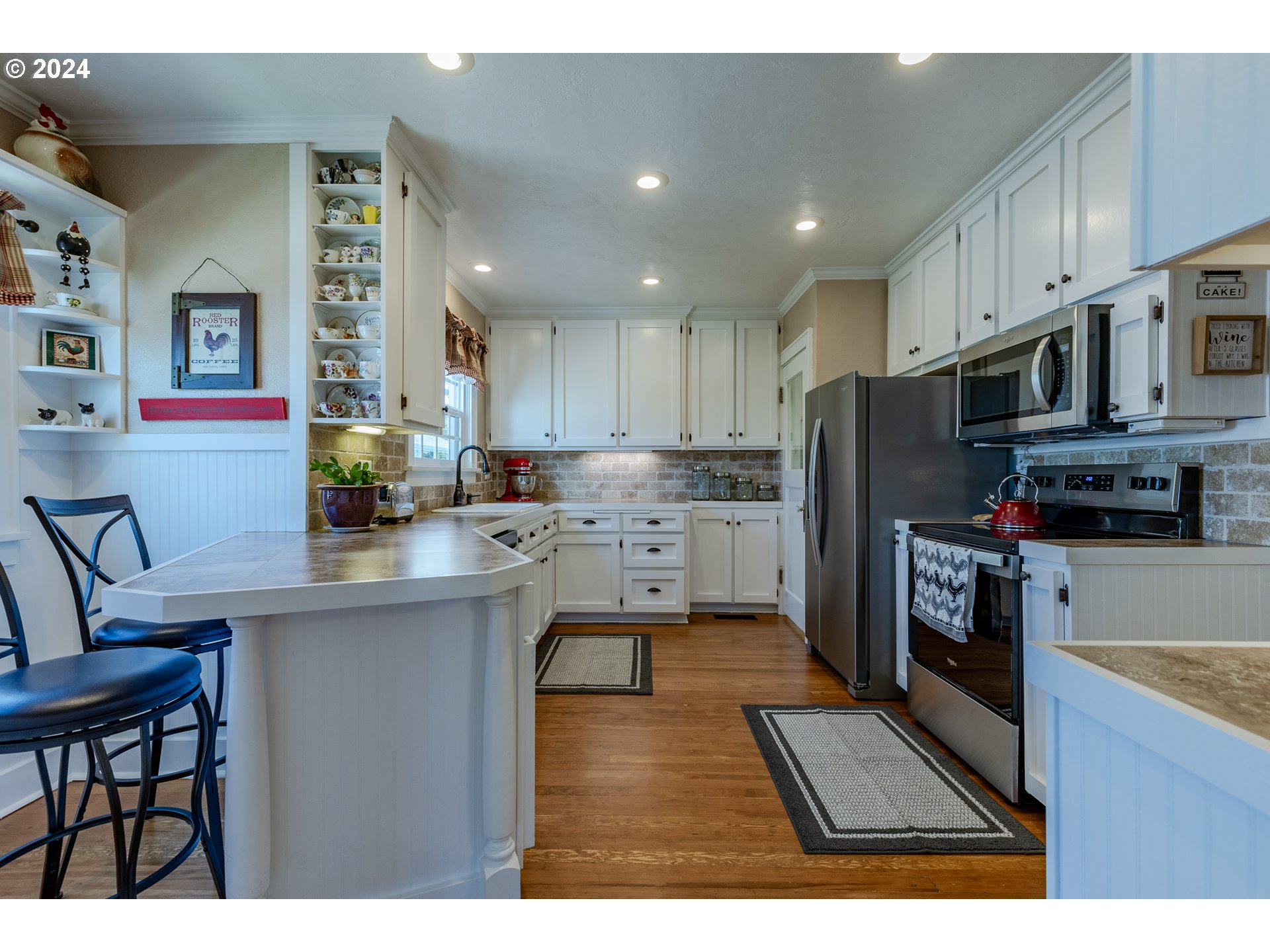 3923 Jasper Road Springfield, OR 97478 - Photo 12 of 48 a kitchen with stainless steel appliances granite countertop a refrigerator a stove top oven a sink and dishwasher