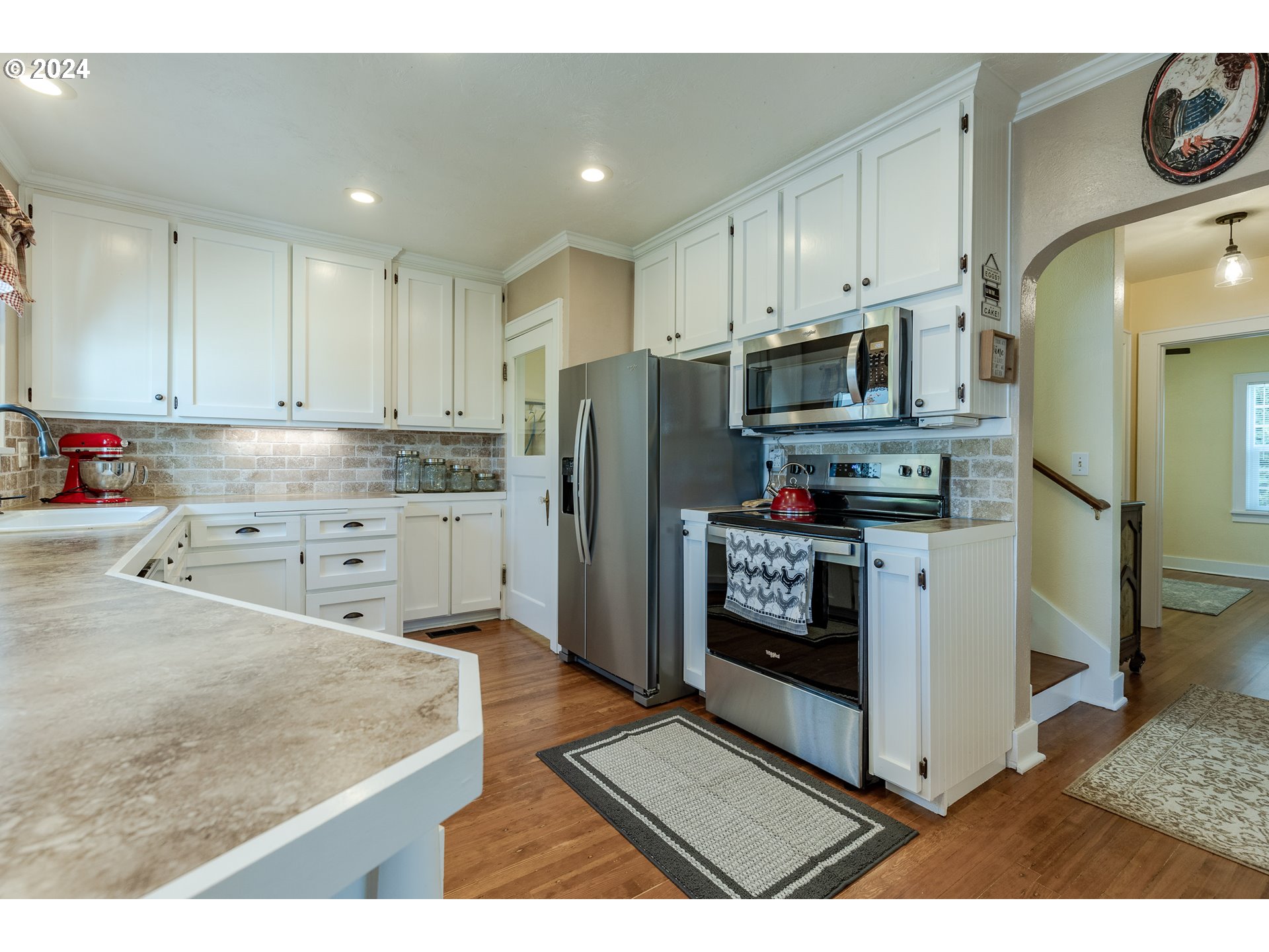 3923 Jasper Road Springfield, OR 97478 - Photo 13 of 48 a kitchen with stainless steel appliances granite countertop a refrigerator stove and white cabinets
