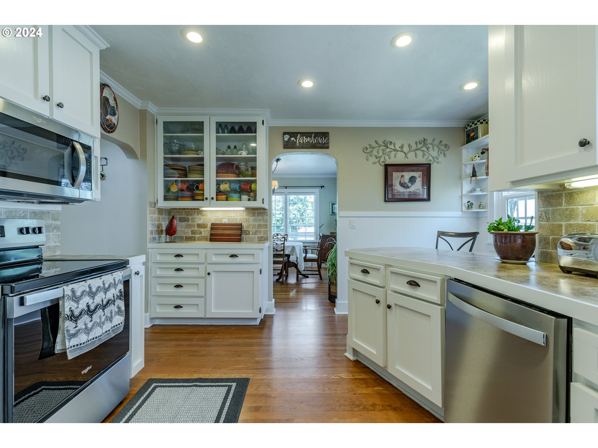 3923 Jasper Road Springfield, OR 97478 - Photo 15 of 48 a kitchen with stainless steel appliances kitchen island granite countertop a stove a sink and a refrigerator