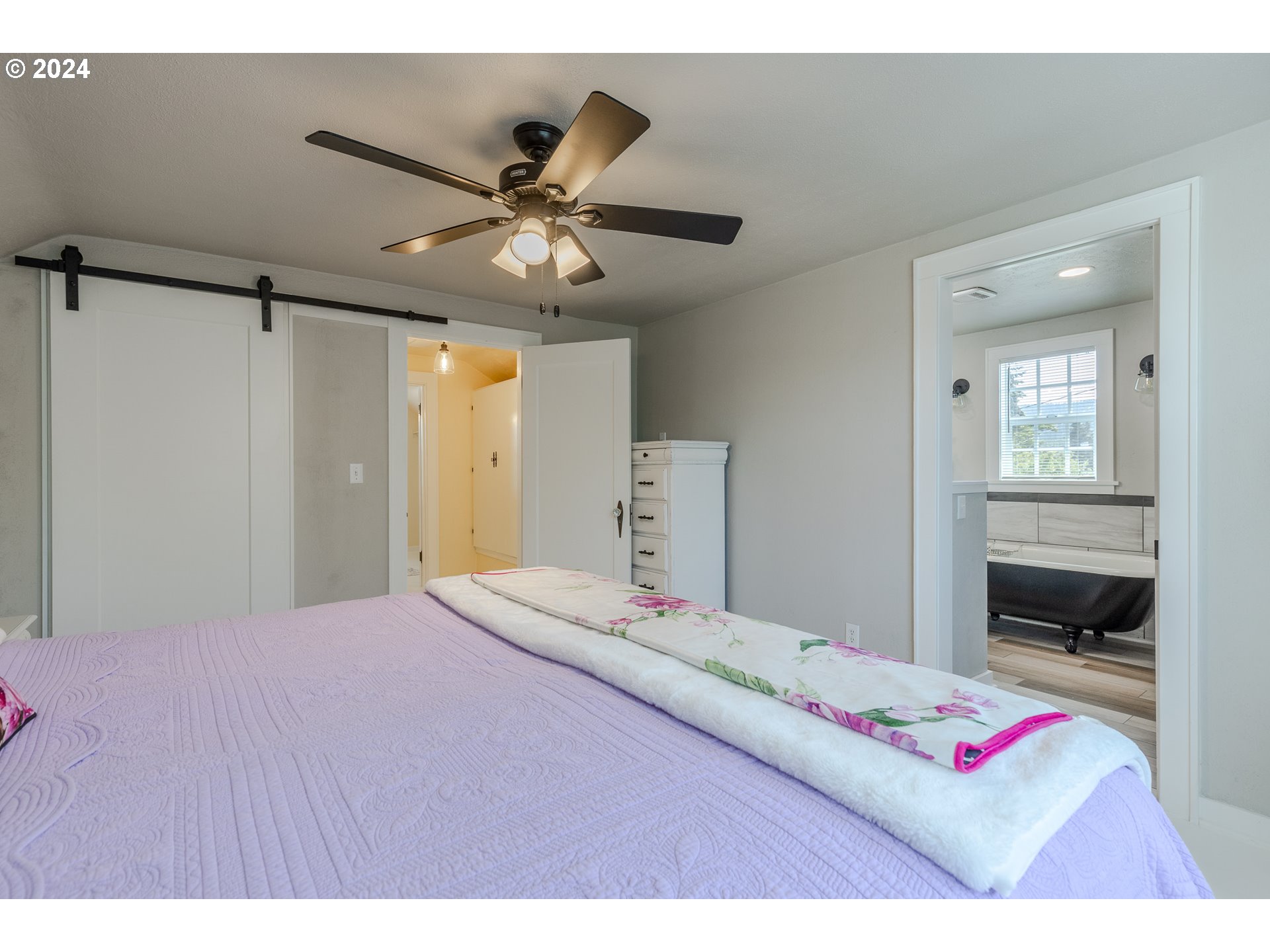 3923 Jasper Road Springfield, OR 97478 - Photo 22 of 48 a bedroom with a bed and a chandelier