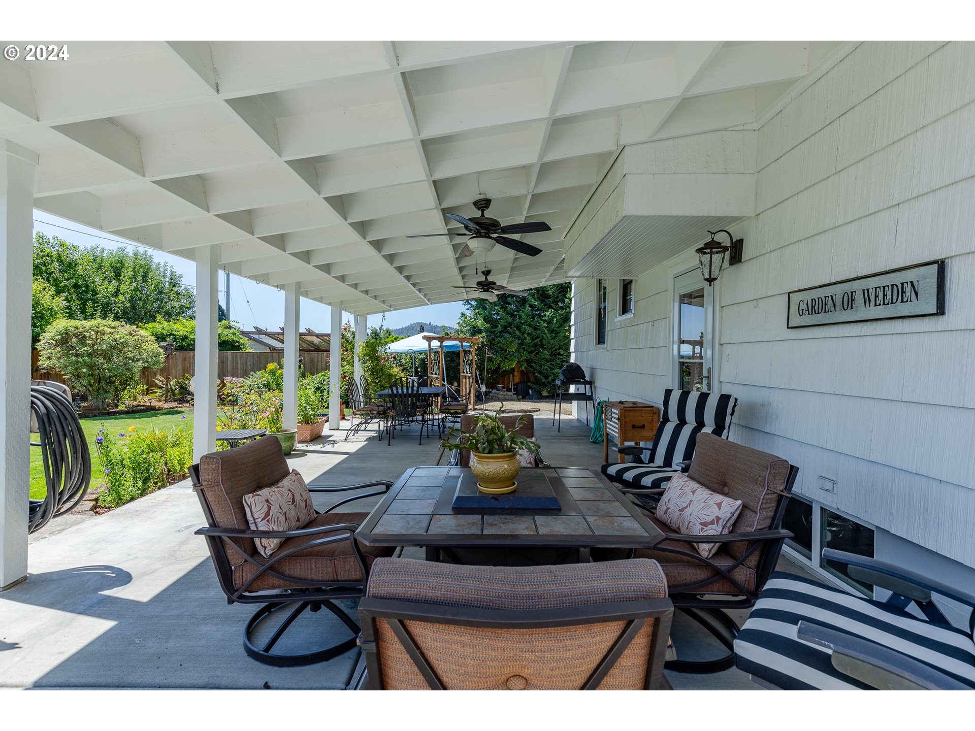 3923 Jasper Road Springfield, OR 97478 - Photo 39 of 48 a view of a patio with a dining table and chairs
