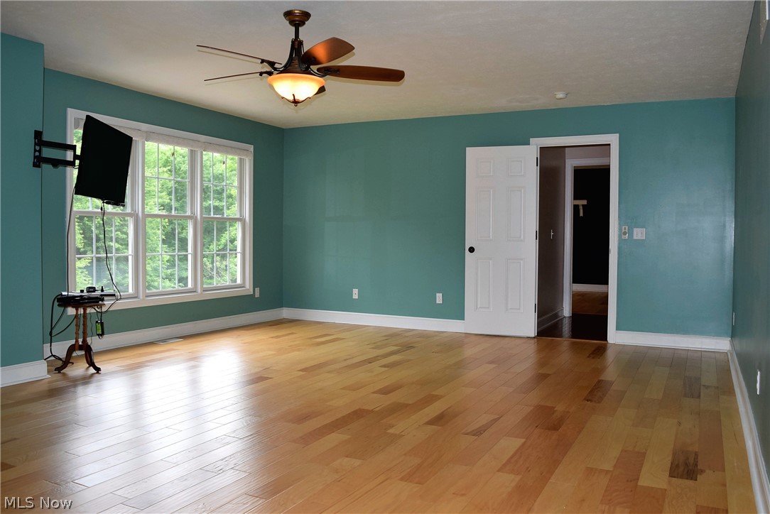 17000 Wing Road Chagrin Falls, OH 44023 - Photo 13 of 35 Mater Bedroom view from bath access towards door to upper hallway with triple windows at left overlooking pool and rear wooded 2 acres.