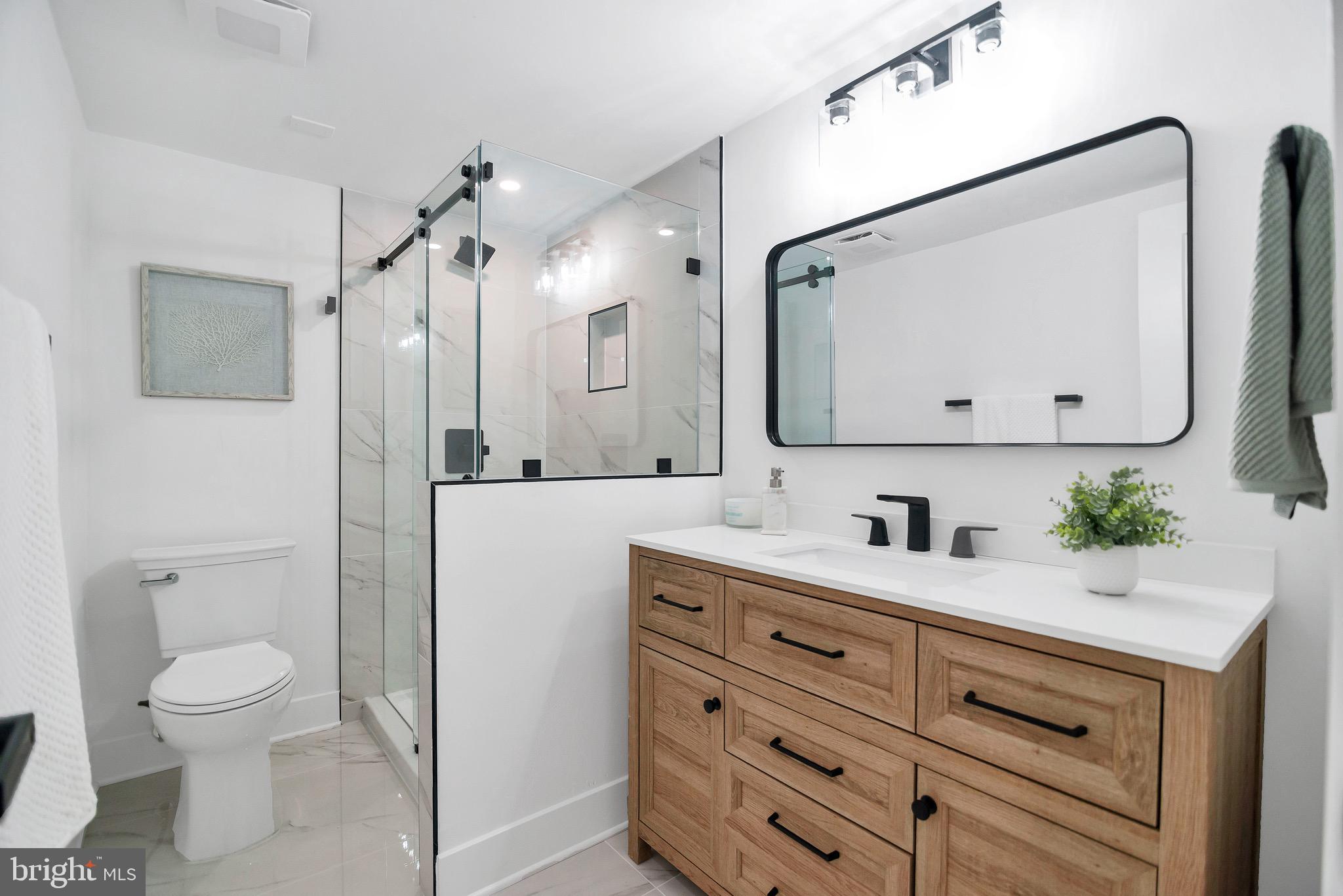6101 Edsall Road, Unit 602 Alexandria, VA 22304 - Photo 25 of 38 a bathroom with a granite countertop sink mirror vanity and toilet
