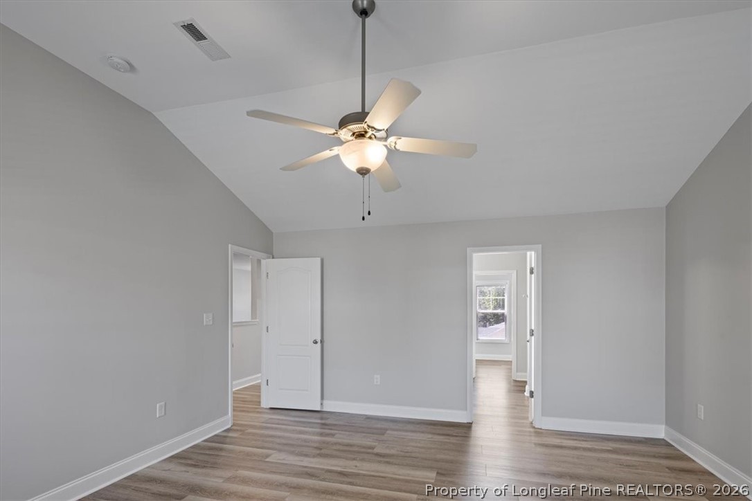 134 Huzzas Circle Cameron, NC 28326 - Photo 18 of 31 a view of an empty room with wooden floor and a ceiling fan