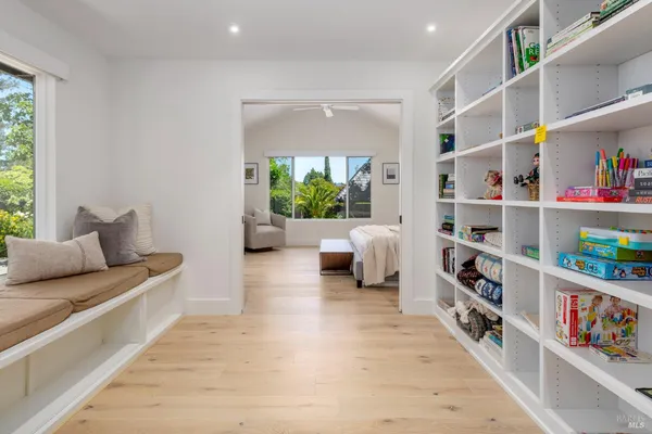 a view of a park with potted plants and large trees