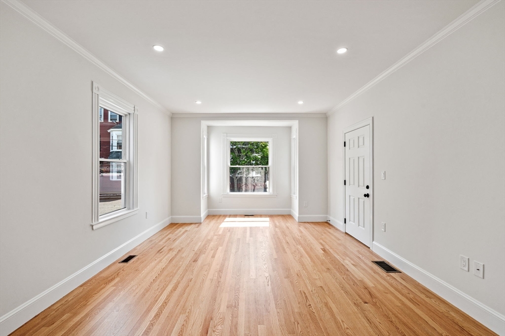 8 Cushing Street, Unit 1 Salem, MA 01970 - Photo 12 of 35 a view of an empty room with wooden floor and a window