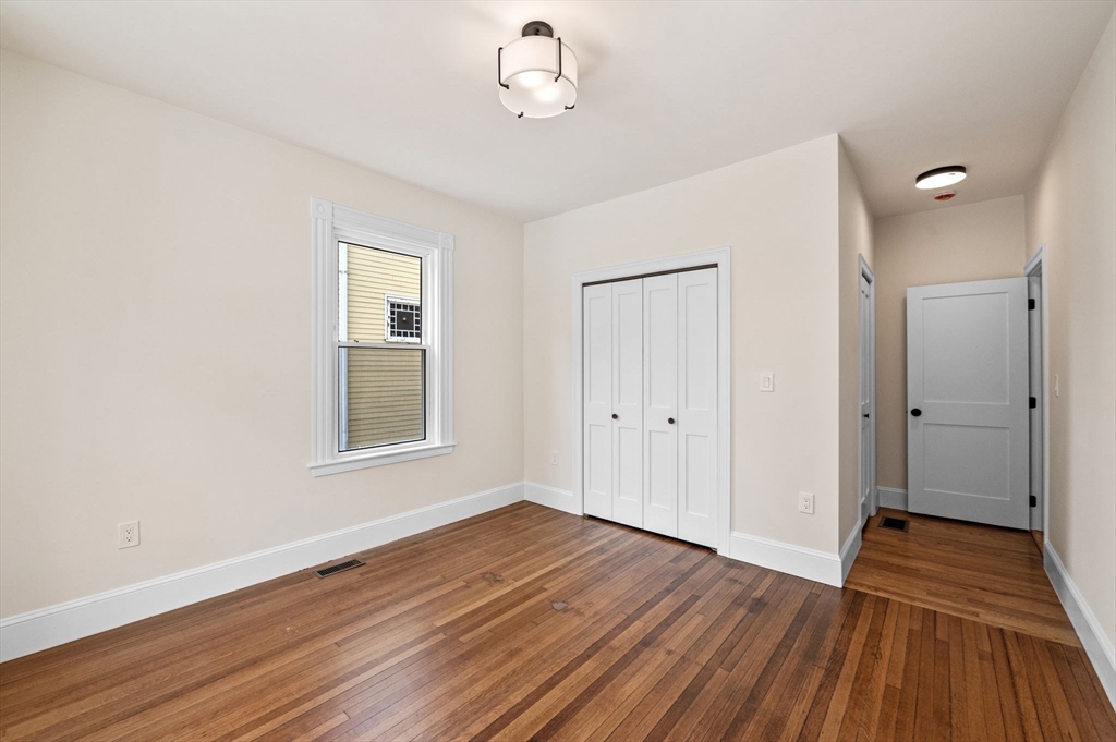 8 Cushing Street, Unit 1 Salem, MA 01970 - Photo 13 of 35 a view of an empty room with wooden floor and a window