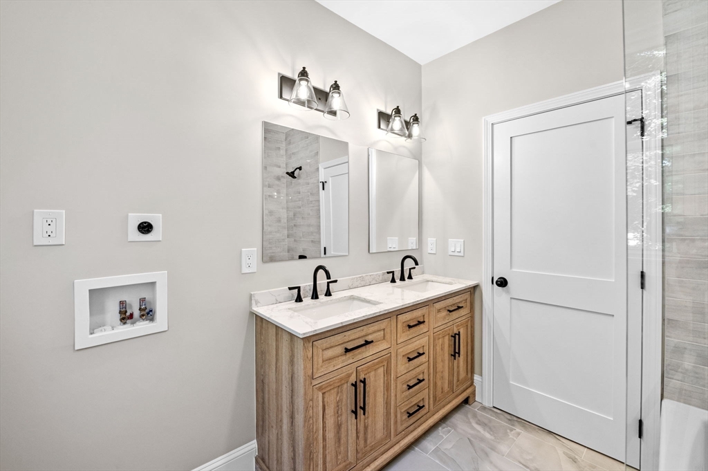 8 Cushing Street, Unit 1 Salem, MA 01970 - Photo 17 of 35 a bathroom with double vanity sink and mirror