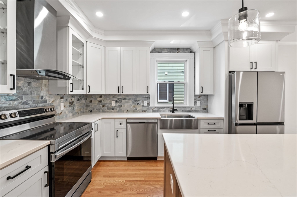 8 Cushing Street, Unit 1 Salem, MA 01970 - Photo 2 of 35 a kitchen with kitchen island a sink stove and refrigerator