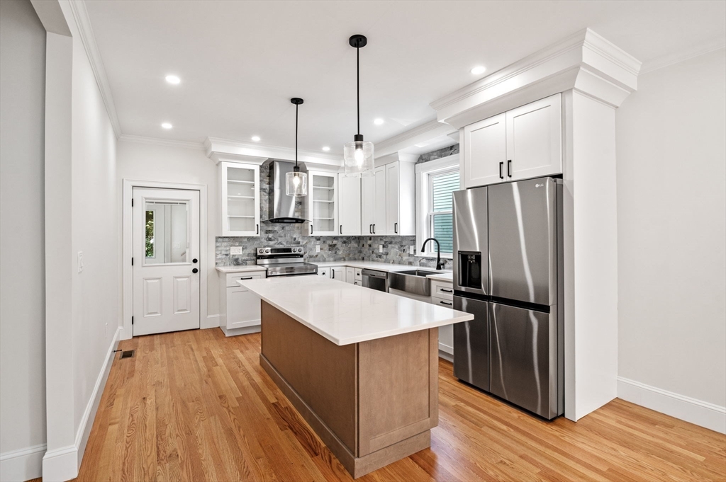 8 Cushing Street, Unit 1 Salem, MA 01970 - Photo 3 of 35 a kitchen with stainless steel appliances a refrigerator and a stove top oven