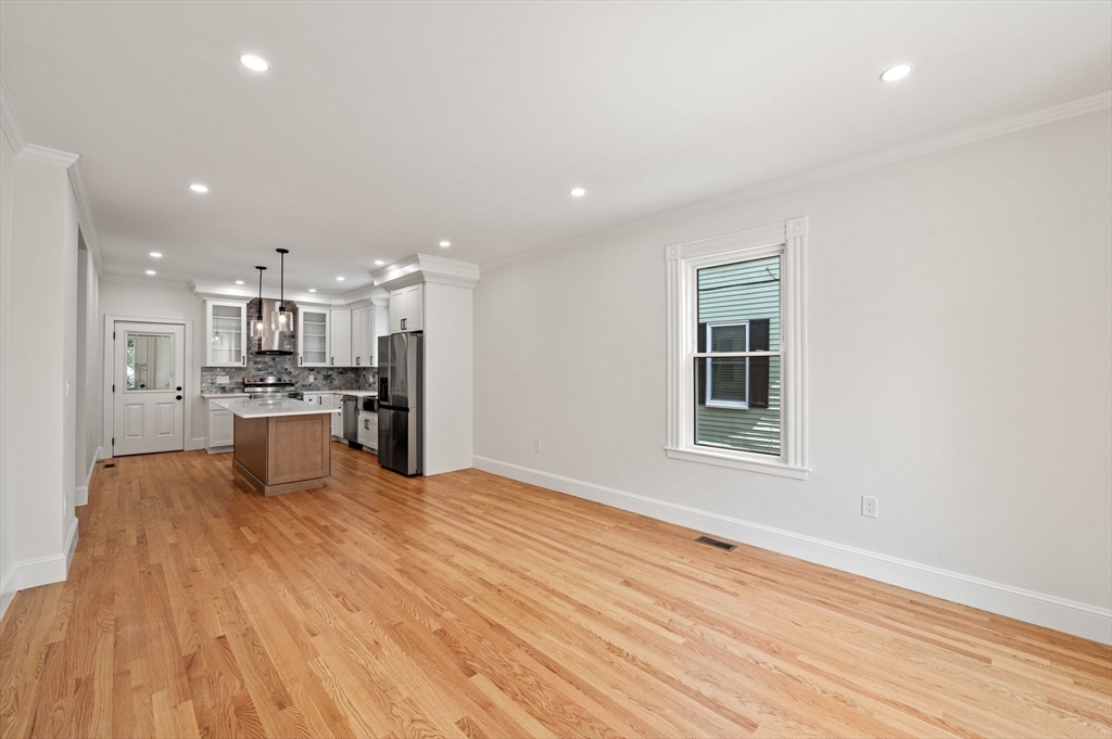 8 Cushing Street, Unit 1 Salem, MA 01970 - Photo 6 of 35 a view of kitchen with kitchen island wooden floor center island and stainless steel appliances