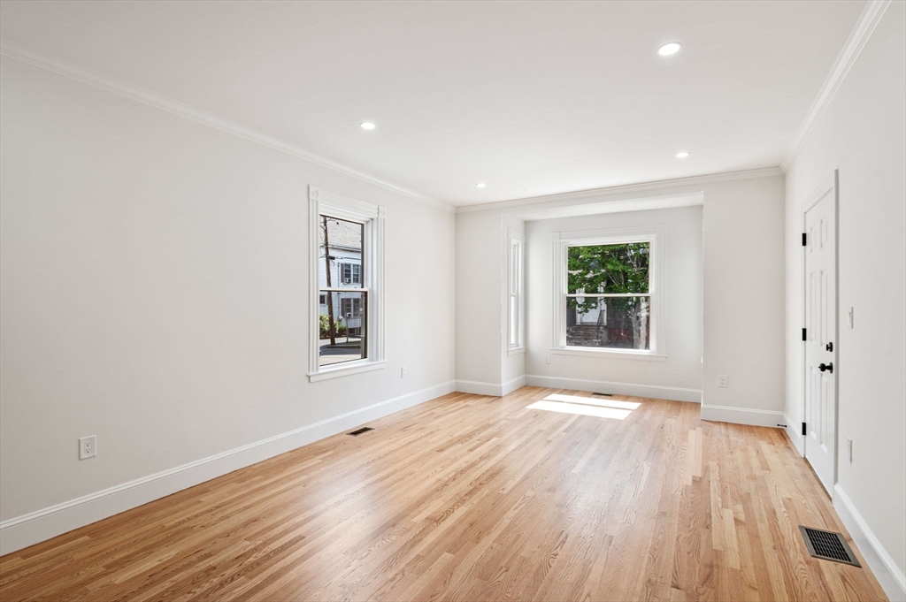 8 Cushing Street, Unit 1 Salem, MA 01970 - Photo 7 of 35 a view of an empty room with wooden floor and a window