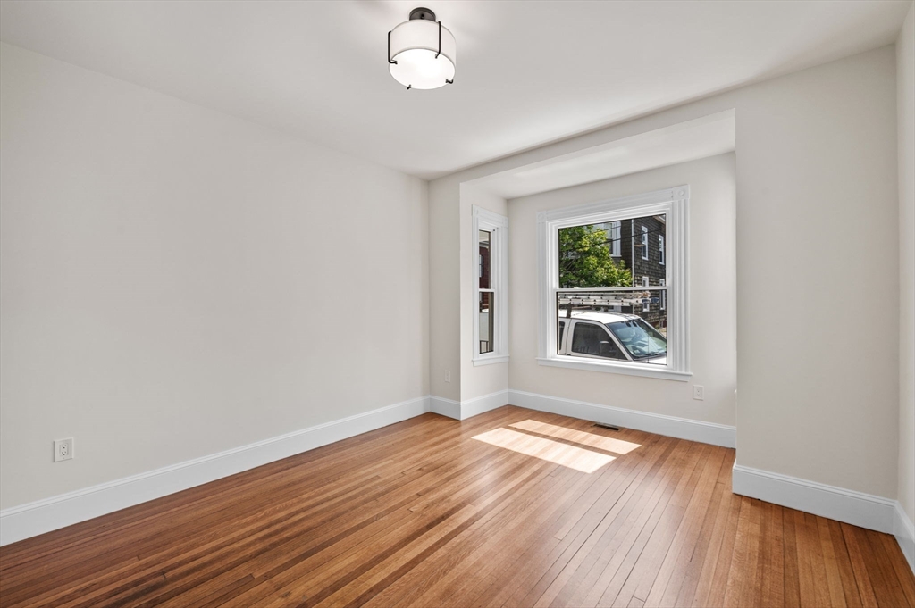 8 Cushing Street, Unit 1 Salem, MA 01970 - Photo 8 of 35 wooden floor in an empty room with a window