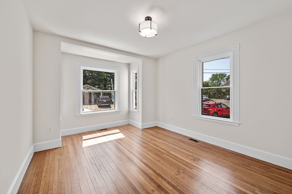 8 Cushing Street, Unit 1 Salem, MA 01970 - Photo 9 of 35 an empty room with wooden floor and windows