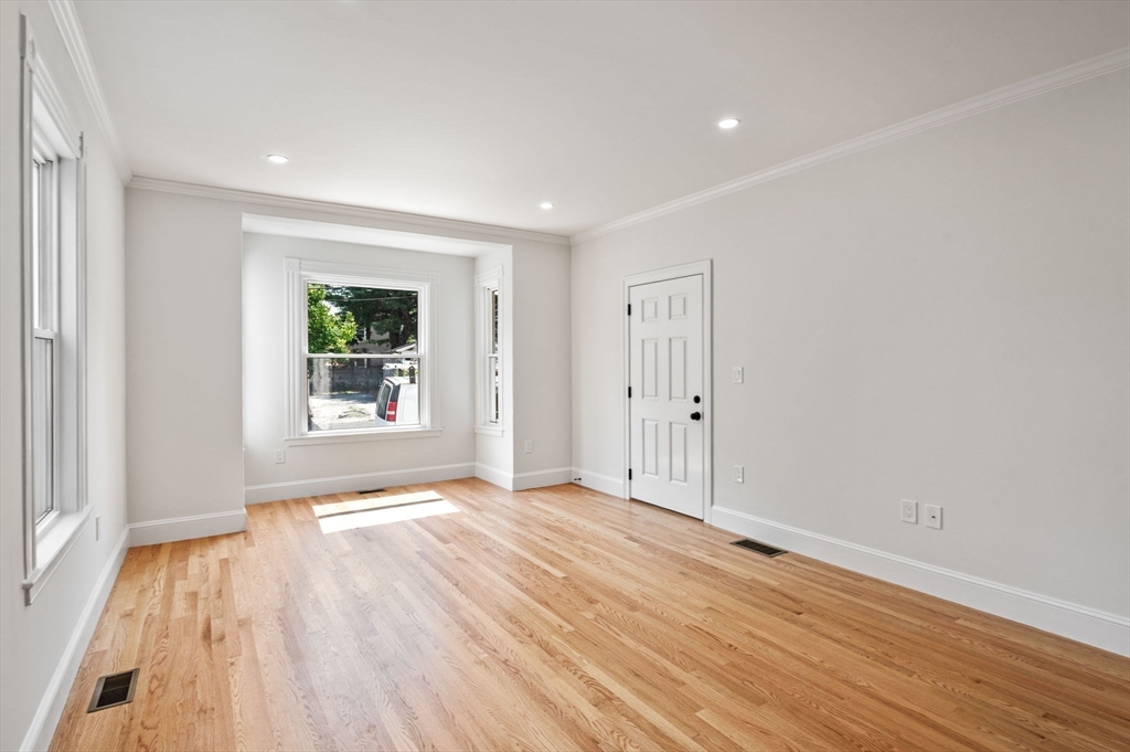 8 Cushing Street, Unit 1 Salem, MA 01970 - Photo 10 of 35 a view of an empty room with wooden floor and a window