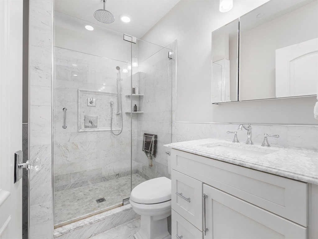 711 East 2nd Street, Unit 2 Boston, MA 02127 - Photo 17 of 25 a bathroom with a granite countertop sink a toilet and shower