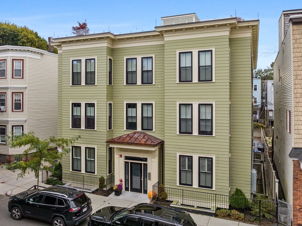 711 East 2nd Street, Unit 2 Boston, MA 02127 - Photo 20 of 25 a front view of a building with car parked
