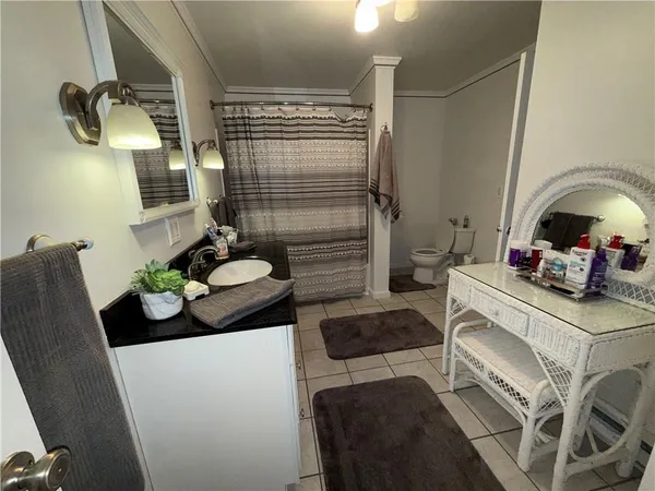 a view of washer and dryer with bathroom in the background