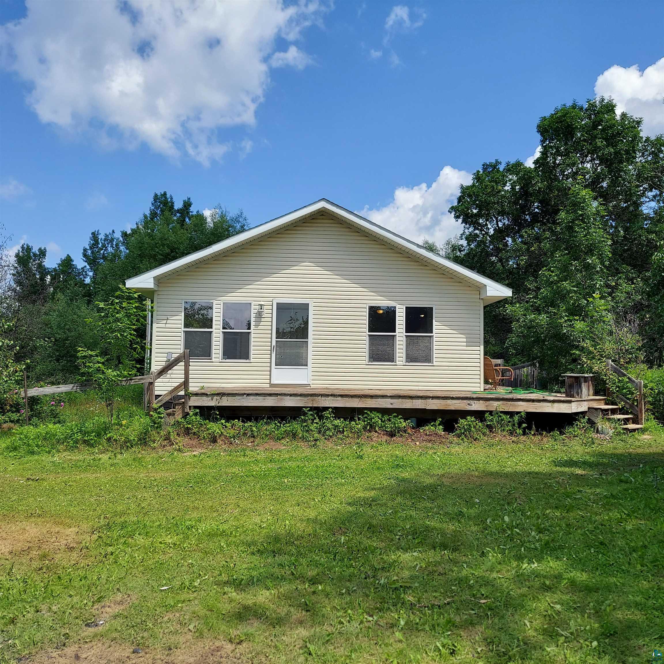 6563 Seville Road Saginaw, MN 55779 - Photo 2 of 28 View of home's exterior with a wooden deck and a yard