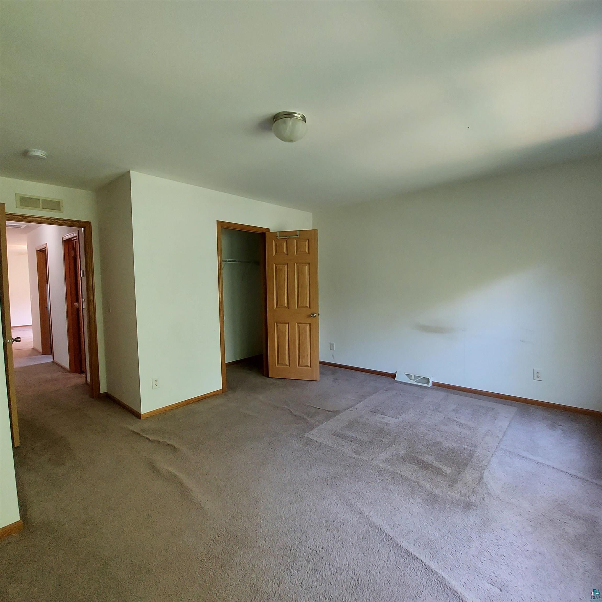 6563 Seville Road Saginaw, MN 55779 - Photo 21 of 28 Unfurnished bedroom with a closet and carpet floors