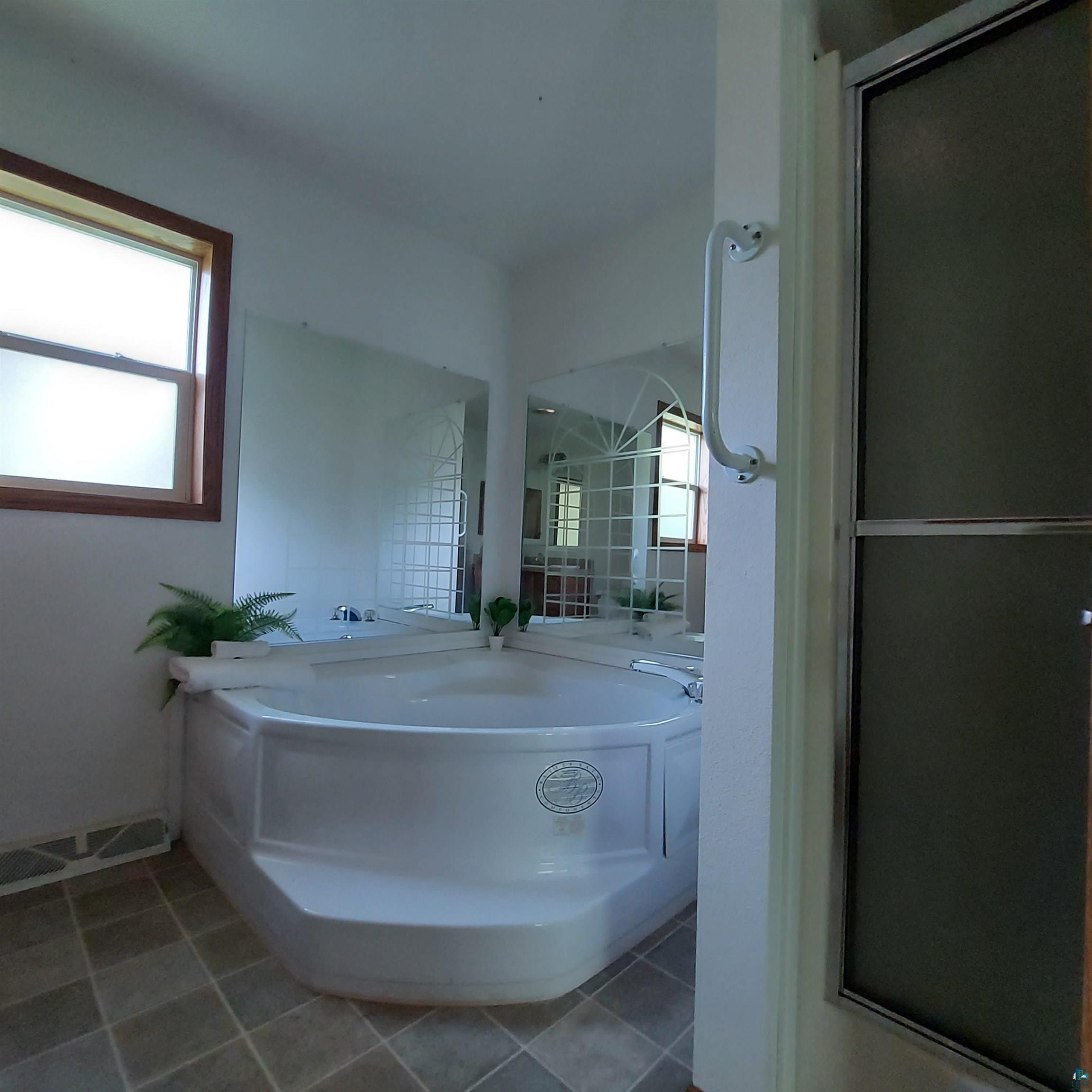 6563 Seville Road Saginaw, MN 55779 - Photo 27 of 28 Bathroom featuring shower with separate bathtub and tile patterned floors