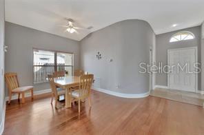 1664 Portsmouth Lake Drive Brandon, FL 33511 - Photo 17 of 38 a view of a dining room with furniture and wooden floor