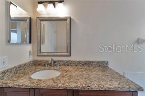 1664 Portsmouth Lake Drive Brandon, FL 33511 - Photo 22 of 38 a bathroom with a granite countertop sink and a mirror