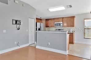 1664 Portsmouth Lake Drive Brandon, FL 33511 - Photo 4 of 38 a kitchen with stainless steel appliances granite countertop a stove a sink and a refrigerator
