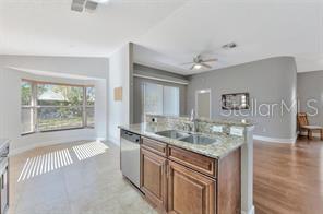 1664 Portsmouth Lake Drive Brandon, FL 33511 - Photo 5 of 38 a bathroom with a granite countertop sink a mirror and a bathtub