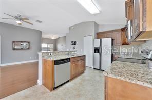1664 Portsmouth Lake Drive Brandon, FL 33511 - Photo 8 of 38 a kitchen with stainless steel appliances granite countertop a sink stove and refrigerator