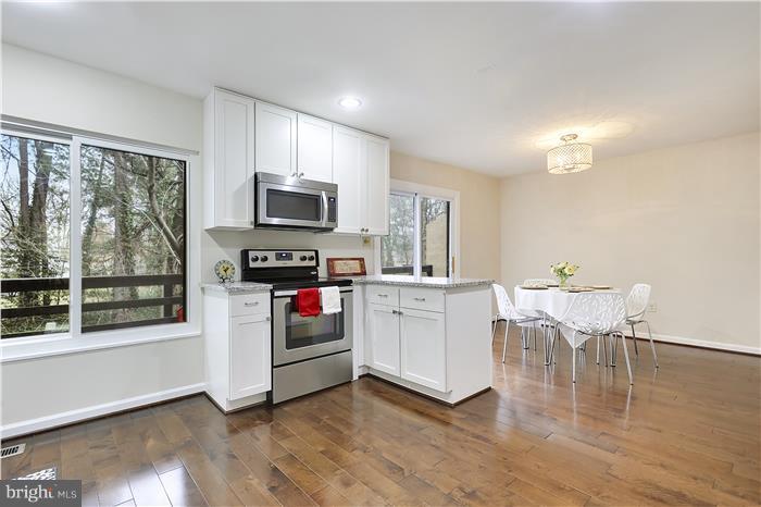11056 Saffold Way Reston, VA 20190 - Photo 7 of 27 Kitchen w/ wood floors, stainless steel appliances