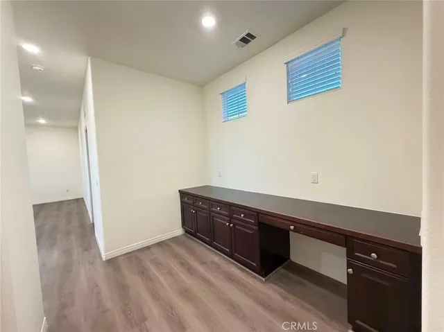 a room with wooden floor and cabinet
