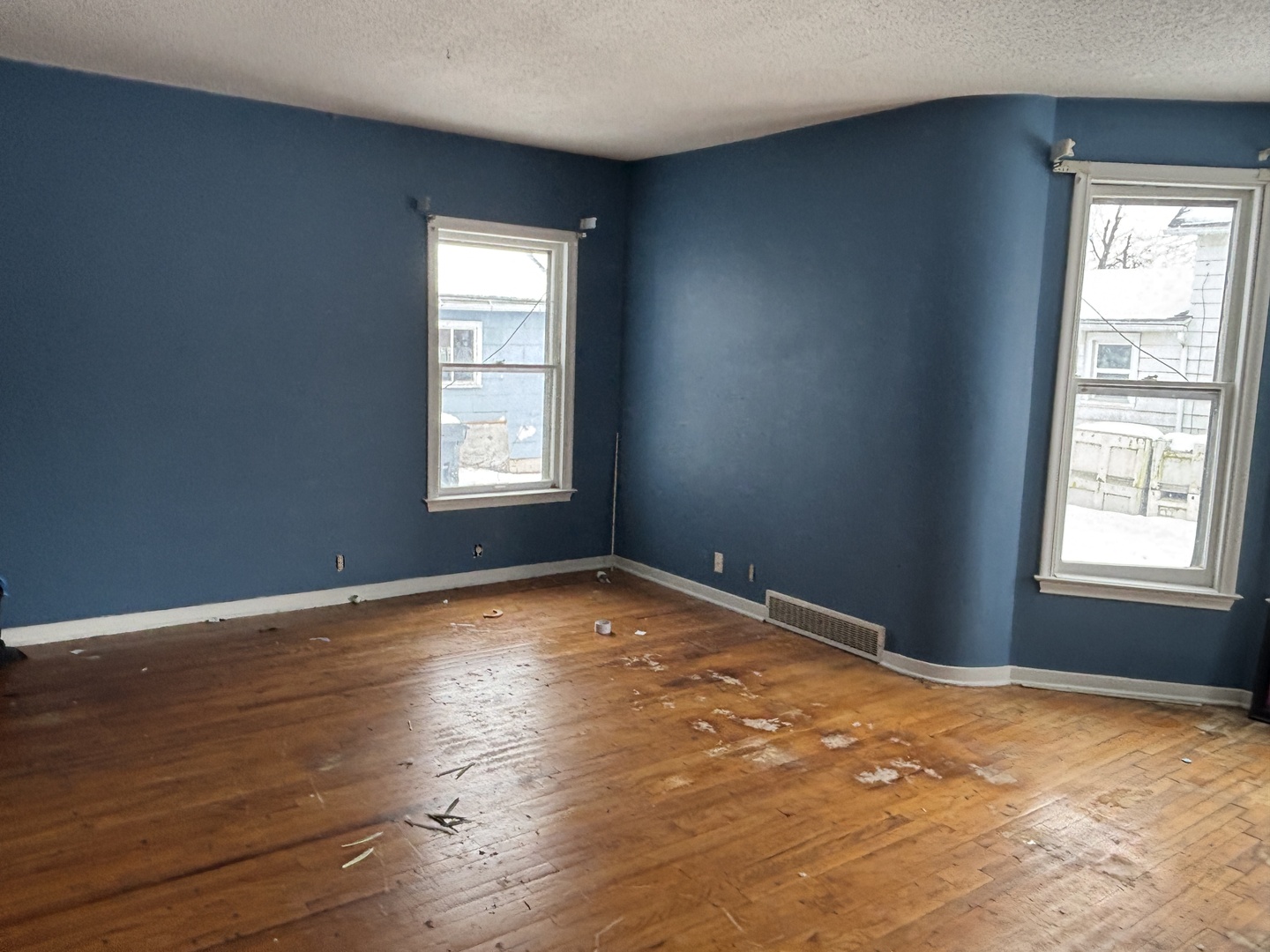2235 Pershing Boulevard Clinton, IA 52732 - Photo 2 of 10 an empty room with wooden floor and windows