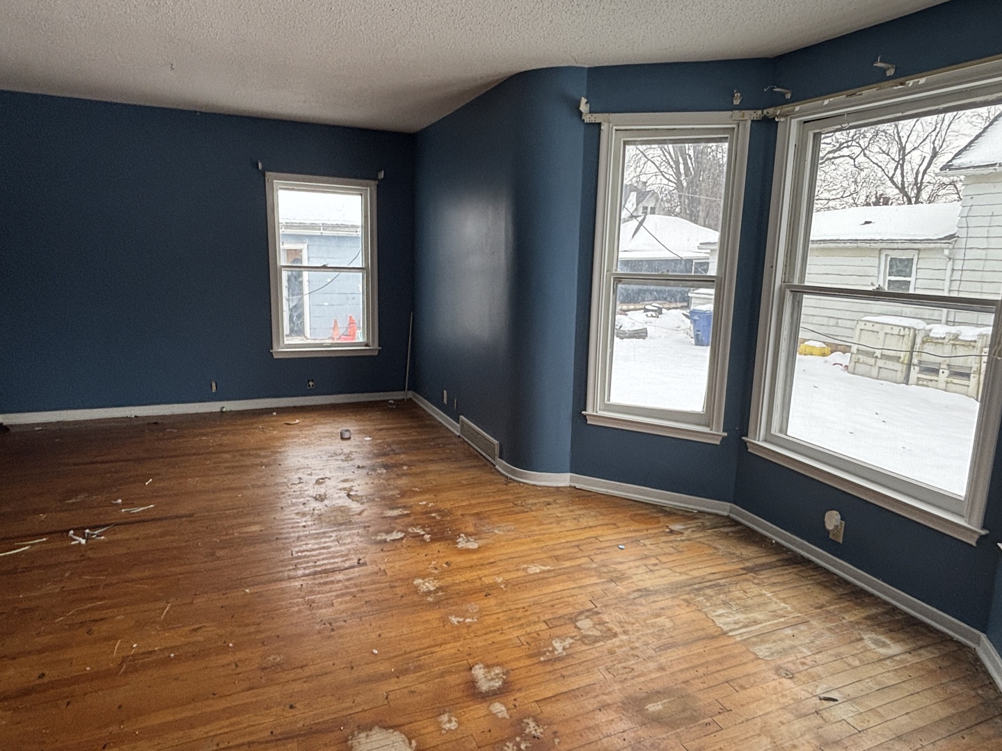 2235 Pershing Boulevard Clinton, IA 52732 - Photo 3 of 10 a view of an empty room with wooden floor and a window