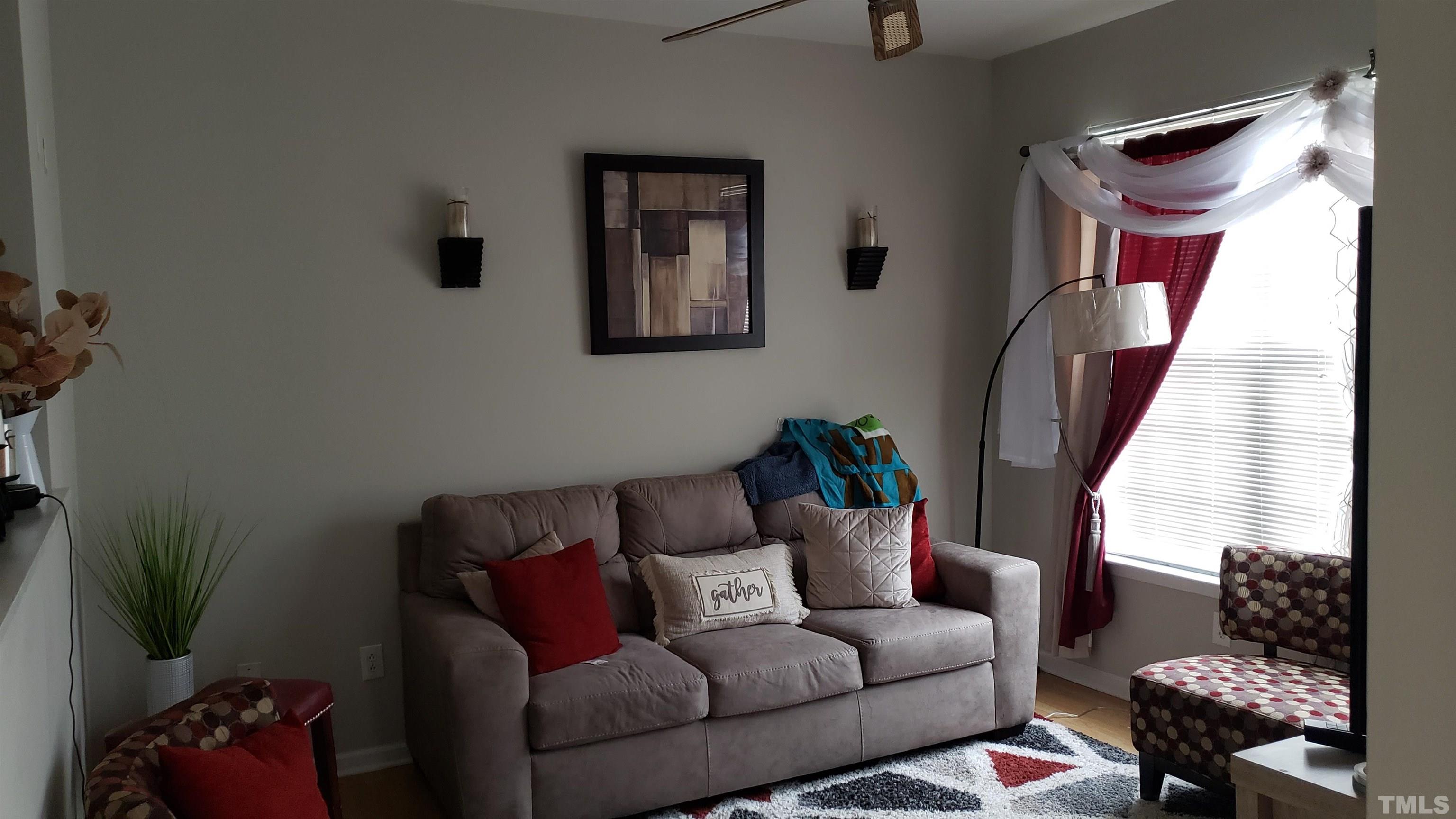 4125 Standing Rock Way Raleigh, NC 27604 - Photo 4 of 11 a living room with furniture and a potted plant