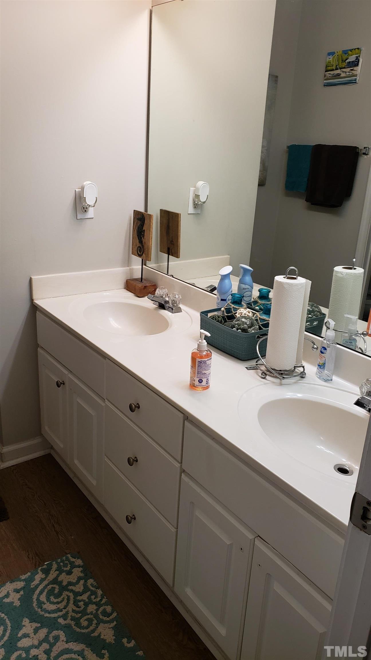 4125 Standing Rock Way Raleigh, NC 27604 - Photo 7 of 11 a bathroom with a double vanity sink and a mirror