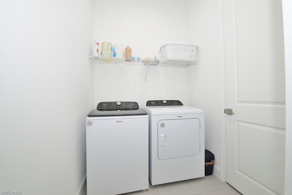 7299 Cayo Coco Lane Naples, FL 34113 - Photo 14 of 18 a utility room with dryer and washer