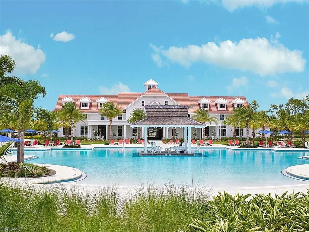 7299 Cayo Coco Lane Naples, FL 34113 - Photo 16 of 18 a view of a lake with a building in the background