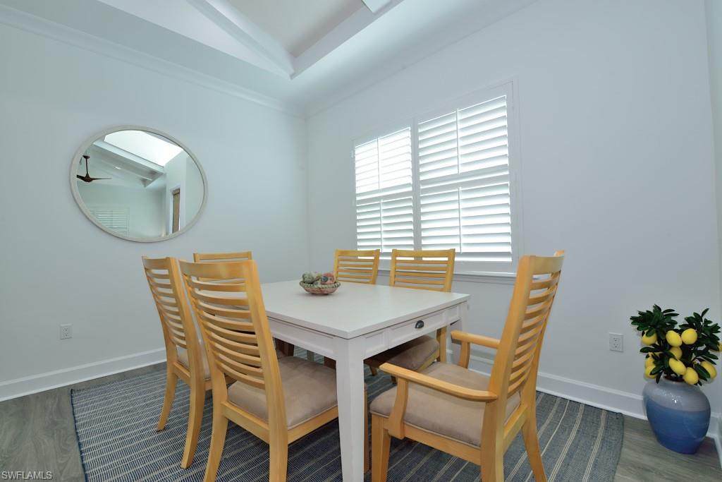 7299 Cayo Coco Lane Naples, FL 34113 - Photo 3 of 18 a view of a dining room with furniture and wooden floor