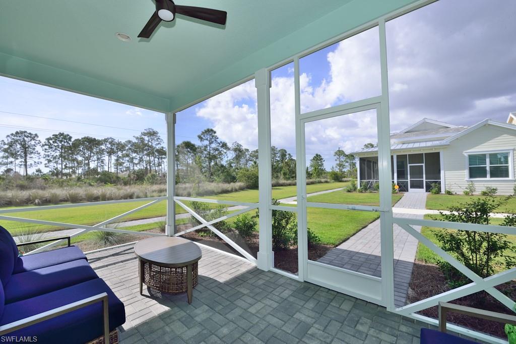 7299 Cayo Coco Lane Naples, FL 34113 - Photo 10 of 18 a view of a patio with chairs and a yard